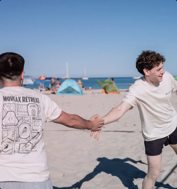 Due colleghi che si battono il cinque durante una partita in spiaggia
